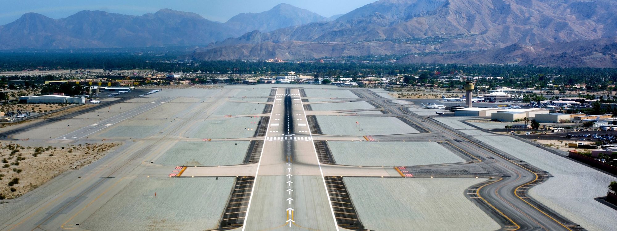 Palm Springs International Airport from the air on final approach to runway 13R, with the mountains behind